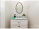 Charming bathroom featuring marble countertops, white cabinets, and a modern oval mirror at 5106 Stone Park Dr, Charlotte, NC 28269