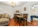 Dining area with hardwood floors, a chandelier, and a view of the fireplace at 5106 Stone Park Dr, Charlotte, NC 28269