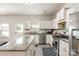 Bright kitchen features white cabinets, stainless steel appliances, and a large island with granite countertops at 5106 Stone Park Dr, Charlotte, NC 28269