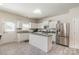 Bright kitchen featuring white cabinets, granite countertops, stainless steel appliances, and an island at 5106 Stone Park Dr, Charlotte, NC 28269