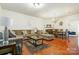 Open-concept living and dining area featuring hardwood floors, a fireplace, and ample natural light at 5106 Stone Park Dr, Charlotte, NC 28269