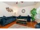 Inviting living room showcasing hardwood floors, large windows, and comfortable blue couches at 5106 Stone Park Dr, Charlotte, NC 28269
