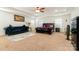 Spacious main bedroom with a tray ceiling, neutral carpet, and a comfortable sitting area at 5106 Stone Park Dr, Charlotte, NC 28269