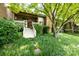 Landscaped backyard featuring a patio, lush greenery, and mature trees offering shade and privacy at 5128 Dunes Ct, Charlotte, NC 28226