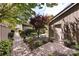 Charming backyard with a brick-paved pathway leading to the private side entrance, surrounded by lush plantings at 5128 Dunes Ct, Charlotte, NC 28226