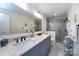 Modern bathroom featuring a double vanity, granite counters, and a glass-enclosed shower at 5128 Dunes Ct, Charlotte, NC 28226