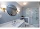 Bright bathroom featuring white cabinets, a quartz countertop, and a glass enclosed shower at 5128 Dunes Ct, Charlotte, NC 28226