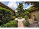 Beautiful courtyard featuring a lush garden, mature trees, and a stone walkway, creating a serene outdoor space at 5128 Dunes Ct, Charlotte, NC 28226