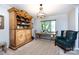 Cozy dining area with natural wood hutch, table, and blue chair near sunlit window at 5128 Dunes Ct, Charlotte, NC 28226