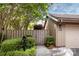 Exterior home entrance with a private fenced yard, verdant landscaping and stone walkway at 5128 Dunes Ct, Charlotte, NC 28226