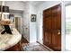 Inviting foyer featuring a hardwood door, marble-topped console, and elegant rug at 5128 Dunes Ct, Charlotte, NC 28226