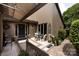 Cozy front porch featuring an awning, outdoor seating, and attractive landscaping at 5128 Dunes Ct, Charlotte, NC 28226