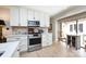 Well-lit kitchen showcases stainless steel range, white cabinets, and eat-in nook near window at 5128 Dunes Ct, Charlotte, NC 28226