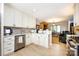 Stylish kitchen with stainless steel dishwasher and white cabinets, open to dining area at 5128 Dunes Ct, Charlotte, NC 28226