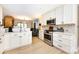 Modern kitchen features white cabinetry, stainless steel appliances, and ample countertop space at 5128 Dunes Ct, Charlotte, NC 28226