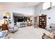 Open-concept living room featuring built-in shelving, white paint, and neutral carpeting at 5128 Dunes Ct, Charlotte, NC 28226