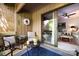 Cozy outdoor patio with comfortable seating, decorative rug, and sliding glass door access to the interior at 5128 Dunes Ct, Charlotte, NC 28226
