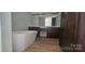 Modern bathroom featuring a soaking tub, dual vanity, and wood-look floors at 532 Robinhood Rd # 27, Maiden, NC 28650