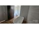 Bright bathroom featuring a standalone tub, modern fixtures, and stylish wood-look flooring at 532 Robinhood Rd # 27, Maiden, NC 28650