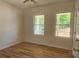 Well-lit bedroom with hardwood floors, ceiling fan and two large windows at 532 Robinhood Rd # 27, Maiden, NC 28650