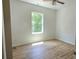 Bright bedroom with hardwood floors and a large window looking out to trees at 532 Robinhood Rd # 27, Maiden, NC 28650