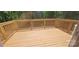 New wooden deck surrounded by lush trees, perfect for outdoor relaxation and entertainment at 532 Robinhood Rd # 27, Maiden, NC 28650