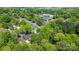 An aerial view shows homes nestled among dense foliage, enhancing privacy and natural beauty at 536 Hartness Rd, Statesville, NC 28677
