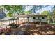 Spacious backyard featuring a wooden play structure and a ramp leading to the back of the house at 536 Hartness Rd, Statesville, NC 28677