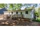 Home exterior with wooden deck and fenced backyard on a sunny day at 536 Hartness Rd, Statesville, NC 28677