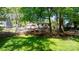 View of the backyard including a play area, mature trees, and a grassy lawn at 536 Hartness Rd, Statesville, NC 28677