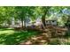 Expansive backyard with mature trees, a play area, and a well-maintained lawn, perfect for outdoor activities at 536 Hartness Rd, Statesville, NC 28677