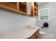 Bathroom featuring white tile, wood cabinets, and a sink with a marble countertop at 536 Hartness Rd, Statesville, NC 28677