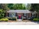 Charming brick home with a red door, set in a well-maintained yard with lush green bushes at 536 Hartness Rd, Statesville, NC 28677