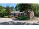 Brick ranch home with a red front door, offering accessible ramp access and lush landscaping at 536 Hartness Rd, Statesville, NC 28677