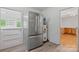 Bright kitchen featuring stainless steel refrigerator, water heater, and wood-look flooring at 536 Hartness Rd, Statesville, NC 28677