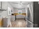 Kitchen with white cabinets, stainless steel refrigerator, and window at 536 Hartness Rd, Statesville, NC 28677