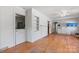 Open living room featuring hardwood floors, white walls, built-in shelving, and convenient utility sink at 536 Hartness Rd, Statesville, NC 28677