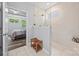 Bathroom with tile shower, tile floors, and wooden bench next to the opening to the main bedroom at 536 Rustlewood Way, Rock Hill, SC 29732