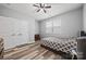 Serene bedroom featuring a gray bed, ceiling fan, closet, and vinyl floors at 536 Rustlewood Way, Rock Hill, SC 29732