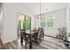 Bright dining area with wood floors, table, modern light fixture, and sliding glass door to outdoor patio at 536 Rustlewood Way, Rock Hill, SC 29732