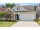 Charming home exterior featuring a stone facade, two-car garage, and well-maintained landscaping at 536 Rustlewood Way, Rock Hill, SC 29732