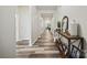 Long hallway featuring wood-look floors, white trim, and a console table at 536 Rustlewood Way, Rock Hill, SC 29732