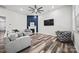 Spacious living room features wood floors, fireplace, and large television for ultimate relaxation at 536 Rustlewood Way, Rock Hill, SC 29732