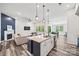 Open-concept living space featuring a kitchen island, living room with fireplace, and dining area at 536 Rustlewood Way, Rock Hill, SC 29732