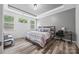 Comfortable main bedroom with tray ceiling, wood floors, desk, and large windows allowing natural light at 536 Rustlewood Way, Rock Hill, SC 29732