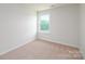 Bright, carpeted bedroom with a window overlooking a lush, green landscape at 6161 Helens Rest Ln, Lincolnton, NC 28092