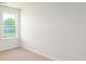 Bright, carpeted bedroom featuring a view to the outside through a large window at 6161 Helens Rest Ln, Lincolnton, NC 28092