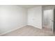 Bright, carpeted bedroom featuring a doorway leading to another room at 6161 Helens Rest Ln, Lincolnton, NC 28092