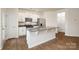 Modern kitchen features white cabinets, stainless steel appliances, granite countertops, and a kitchen island at 6161 Helens Rest Ln, Lincolnton, NC 28092