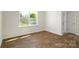 Bright living area features wood-look flooring, natural light, and a door to the outside at 6161 Helens Rest Ln, Lincolnton, NC 28092